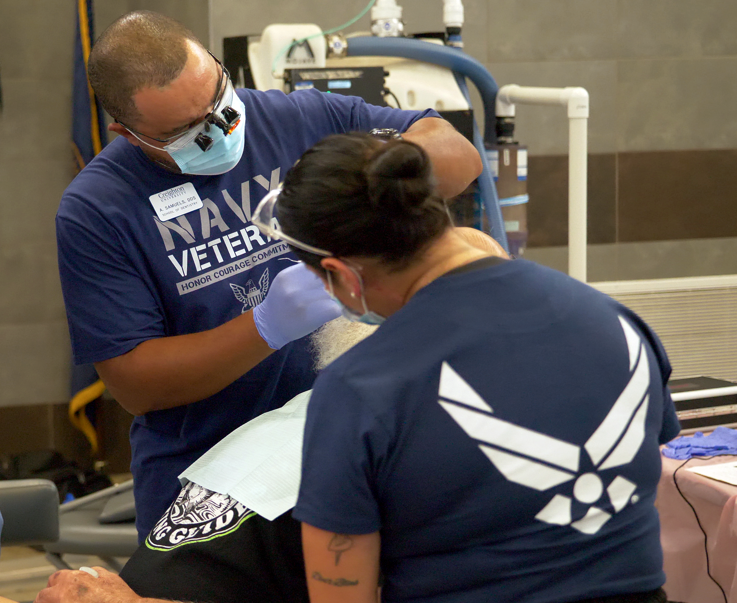 A patient at the 3rd annual Veterans Mission of Mercy Dental Clinic receives care from Navy and Air Force veterans. Several of the dentists, dental hygienists, and other volunteers at the clinic were veterans themselves. 