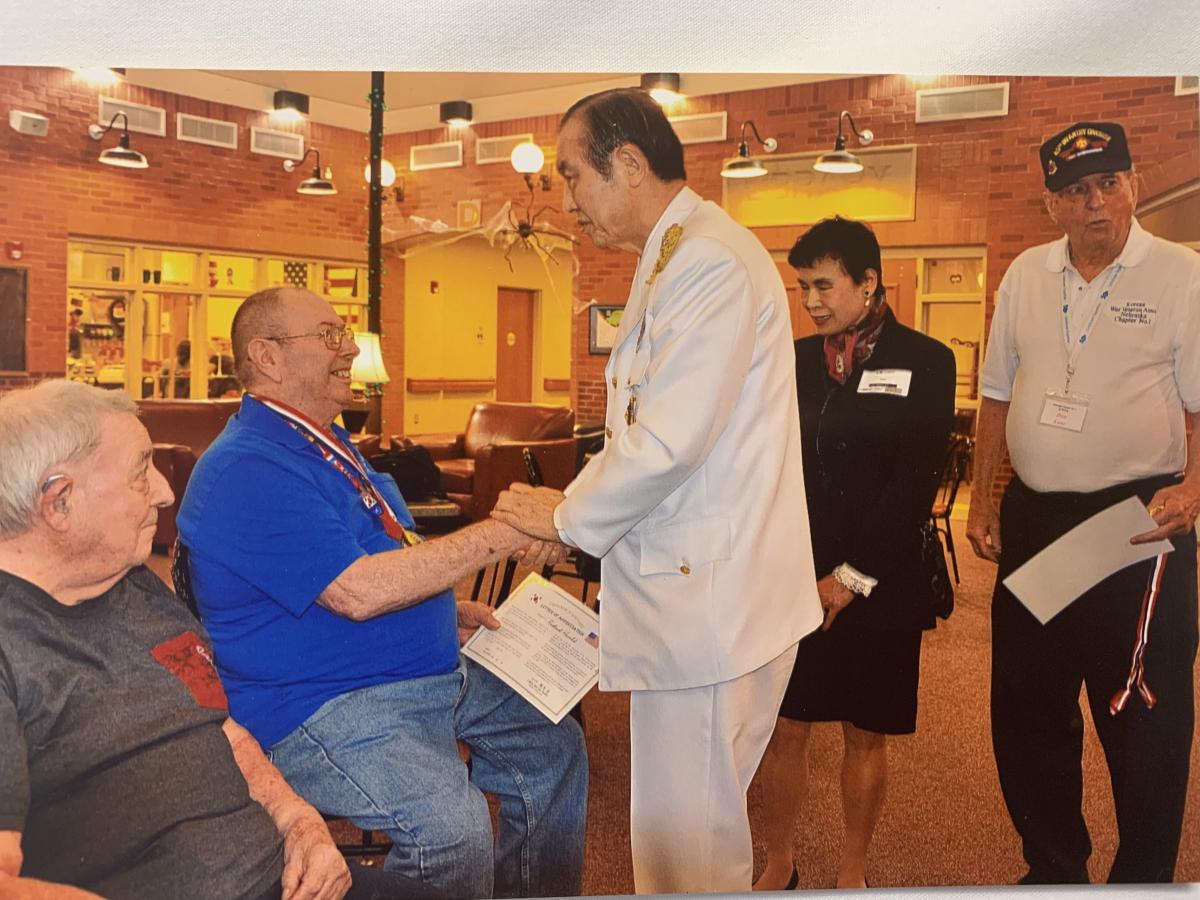 Richard receiving certificate from Korean Government