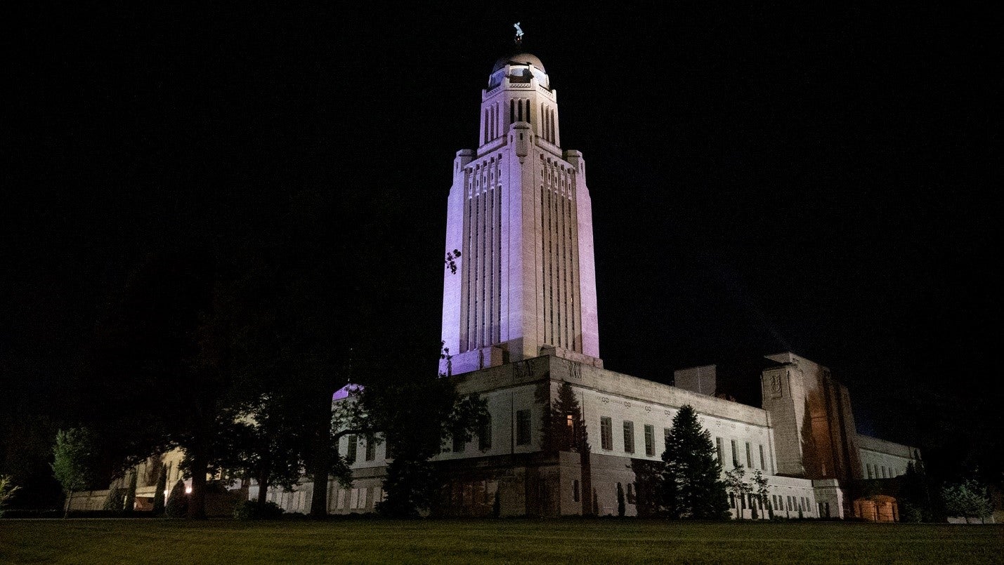 The Nebraska State Capitol lit purple for Purple Heart Day in 2022.