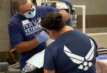 A patient at the 3rd annual Veterans Mission of Mercy Dental Clinic receives care from Navy and Air Force veterans. Several of the dentists, dental hygienists, and other volunteers at the clinic were veterans themselves. 