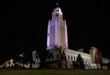 The Nebraska State Capitol lit purple for Purple Heart Day in 2022.