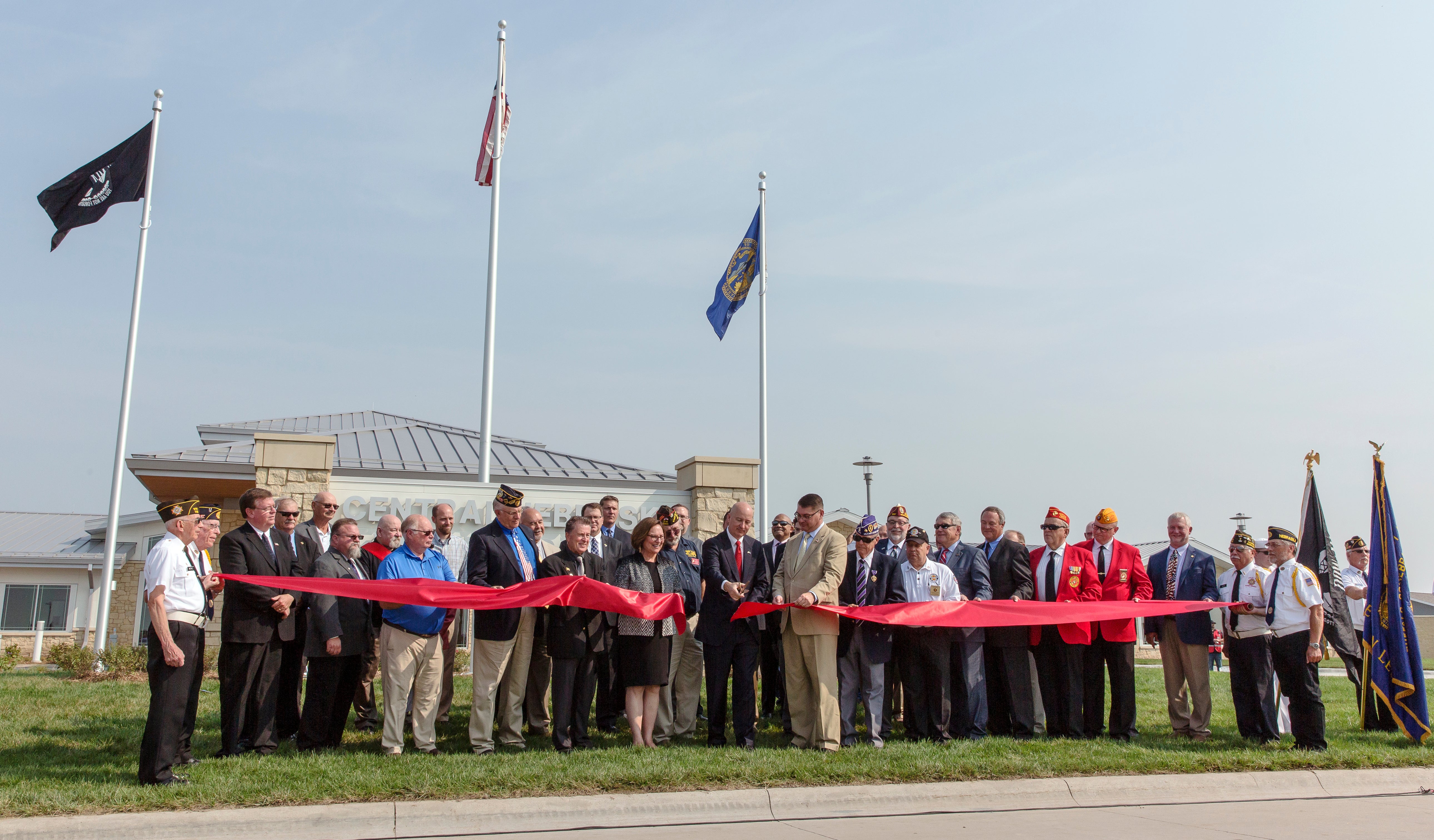 Gov. Ricketts cutting the ribbon on the new Central Nebraska Veterans’ Home in Kearney along with various local, state, and federal representatives that helped with the project. 