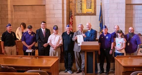 Gov. Ricketts and NDVA Director John Hilgert recognize Purple Heart  recipients in the Warner Chamber of the State Capitol.