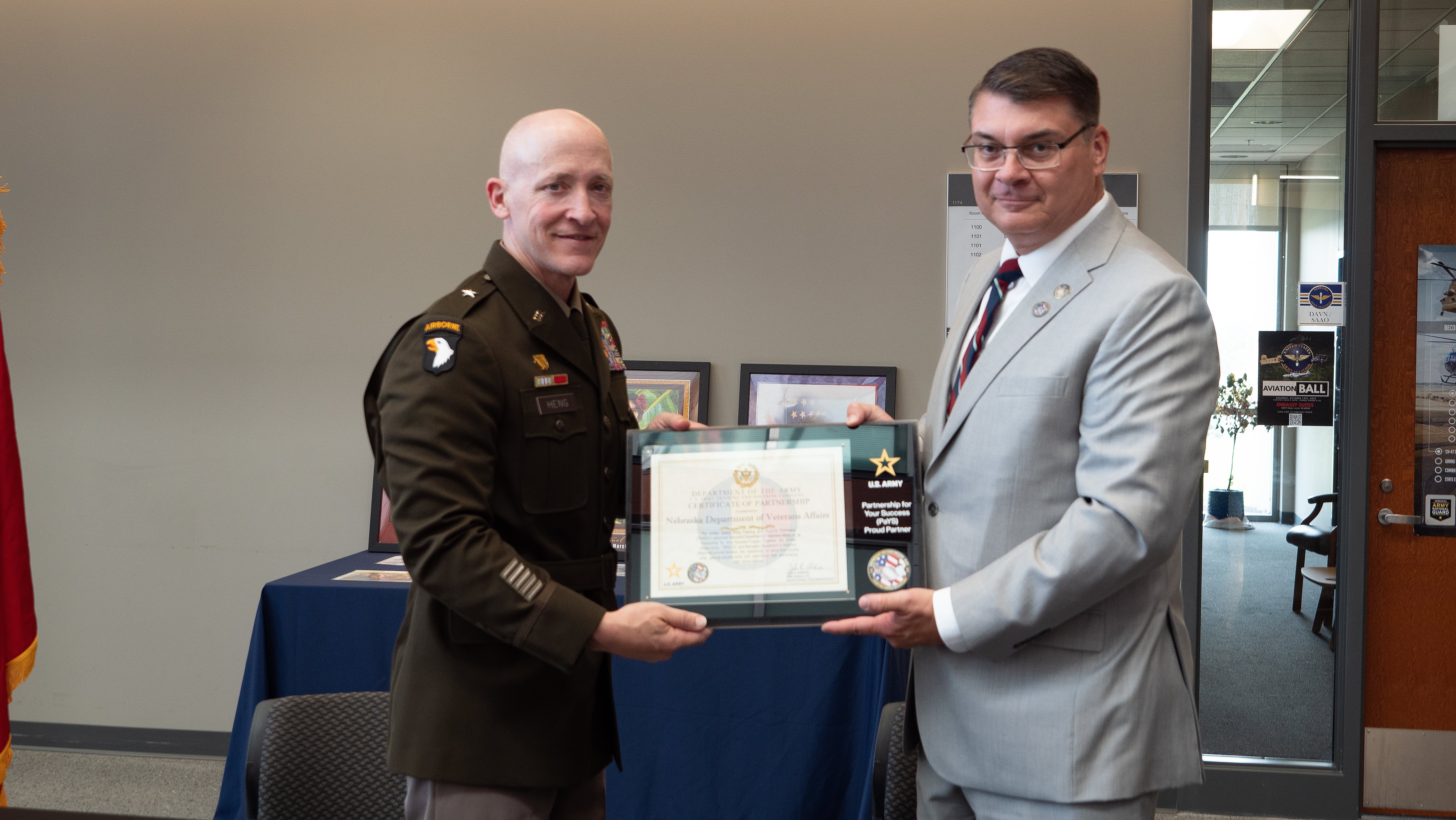 Assistant Adjutant General BG Lynn Heng and NDVA Director John Hilgert display a certificate of partnership. 