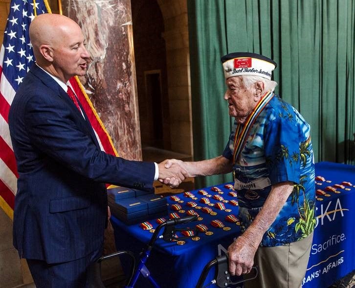 Gov. Ricketts greets Walter Barsell of Wahoo during a ceremony at the State Capitol honoring veterans from across the state.  