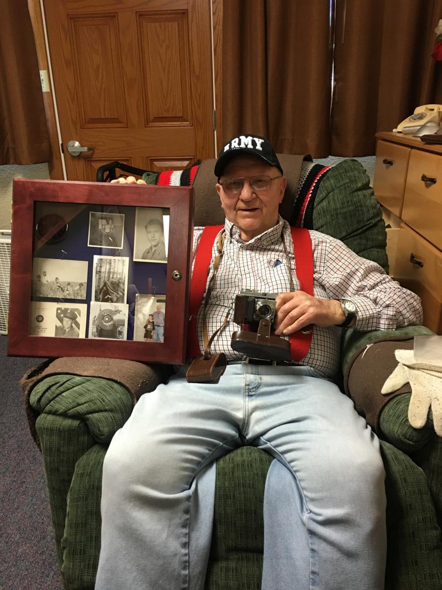 Martin Walter holding case of old photographs